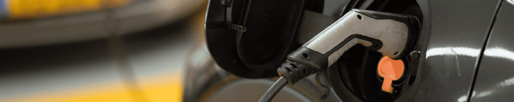 EV Charger plugged into grey EV Vehicle.