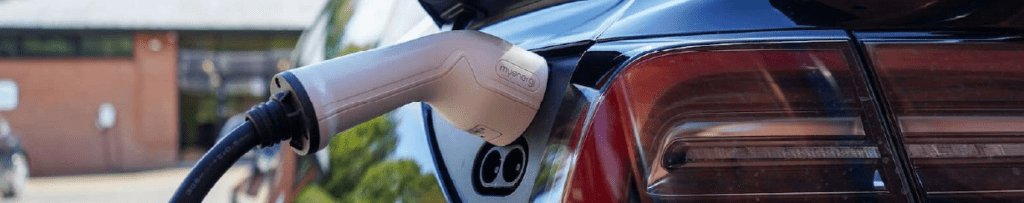 EV Charger plugged into black EV Vehicle.